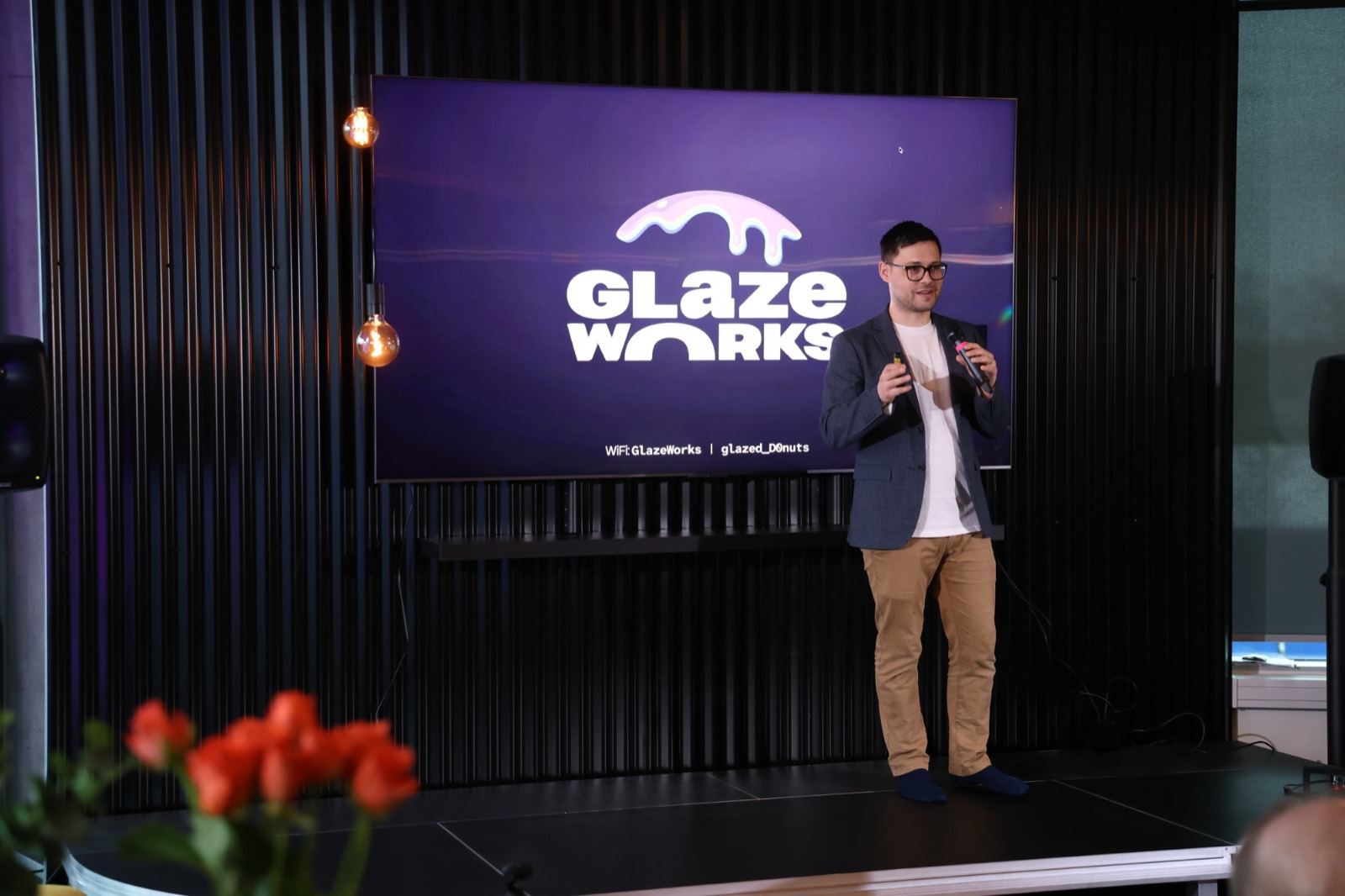 Speaker presenting on stage at Glazeworks