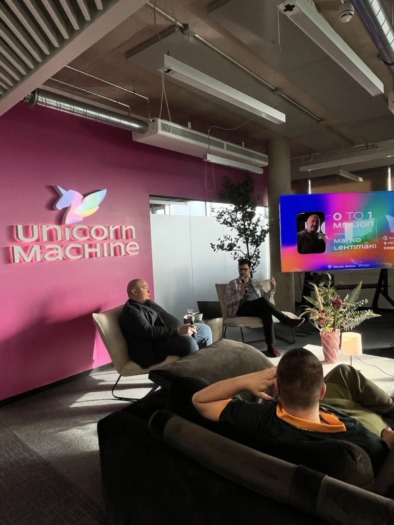Fireside chat in front of the Unicorn Machine wall